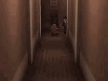 a minecraft character is walking down a hallway in a dark room .