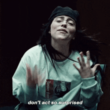 a woman wearing a sweater that says supreme on it