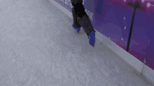 a person is ice skating on a rink with a sign that says ark