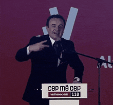 a man stands at a podium that says cep me cep on it