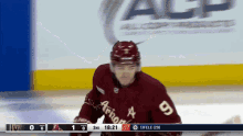 arizona hockey player number 9 on the ice during a hockey game