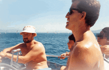 a man without a shirt is driving a boat