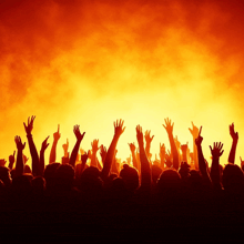 a crowd of people with their hands in the air at a concert