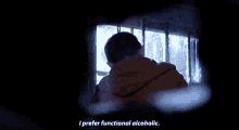 a young man in a dark room says i prefer functional alcoholic .