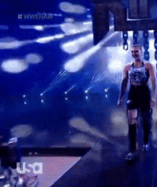 a man is walking on a stage with a usa logo in the background