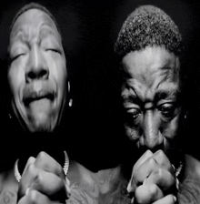 a black and white photo of a man with his eyes closed