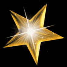 a golden star with a black background and a glowing center