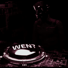 a green light is shining on a circular object in the dark