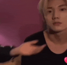 a close up of a person 's face with a pink background .