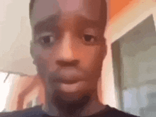 a close up of a man 's face making a funny face in a room .