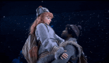 a man and a woman are hugging in the dark