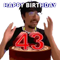 a man celebrates his 43rd birthday by blowing out candles on a cake