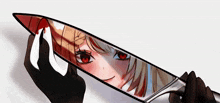 a person holding a knife with a girl 's face on it