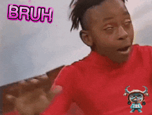 a boy in a red shirt is making a funny face with the words bruh above him