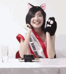 a woman wearing a sash that says team member single