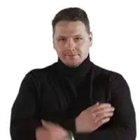 a man in a black turtleneck sweater is clapping his hands