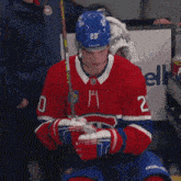 a hockey player wearing a red white and blue jersey with the number 20 on it