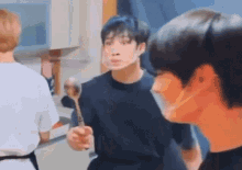 a man wearing a face mask is holding a spoon in his hand .