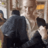 a woman is holding a dog in her arms while standing in a room .