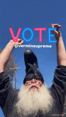 a man with a beard wearing a helmet with the word vote written on it