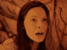 a close up of a woman with her mouth open