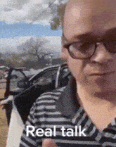 a man wearing glasses and a striped shirt has the words real talk written on his face