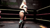 a woman is standing in a wrestling ring with her legs crossed .