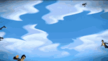 a group of people are flying through a blue sky with clouds