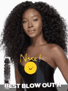 a woman with curly hair is wearing a black strapless top and a yellow smiley face .