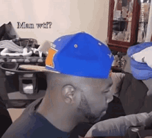 a man wearing a blue hat with the words man wtf written above him
