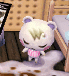 a stuffed animal with a w on its head is standing next to a bed .