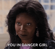 a close up of a woman 's face with the words " you in danger girl " below her