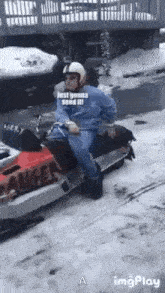 a man is sitting on a snowmobile in the snow and says `` just gonna send it '' .