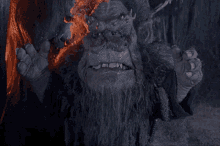 a creature with a beard and horns is standing in the dark