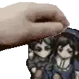 a hand is holding a picture of a man and a woman .