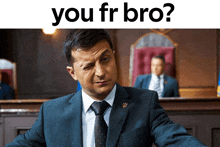 a man in a suit and tie is sitting in front of a mirror with the words you fr bro below him