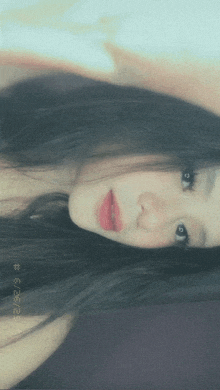 a close up of a woman 's face with a # on the bottom left