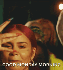 a woman with red hair is saying good monday morning .