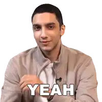 a man in a tan jacket says yeah in white letters