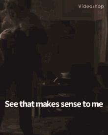 a man in a suit is standing in a room with the words `` see that makes sense to me '' written above him .