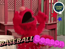 elmo from sesame street is holding a baseball and says baseball season