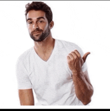 a man in a white t-shirt is giving a thumbs up sign