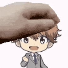 a hand is holding a cartoon character 's head .