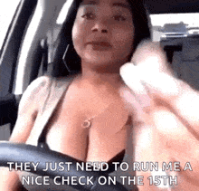 a woman is driving a car and talking on a cell phone while wearing a bra .