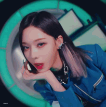 a close up of a woman 's face with a blue jacket