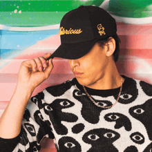 a man wearing a black hat that says glorious