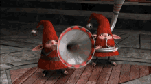 two gnomes in red hats are playing instruments