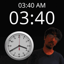 a man with glasses stands in front of a clock that says 03:40 am