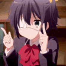 a girl wearing a mask and a red bow tie is pointing up