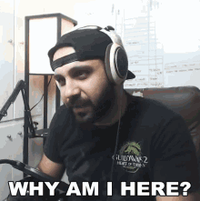 a man wearing headphones and a shirt that says guildwars 2 heart of thorns